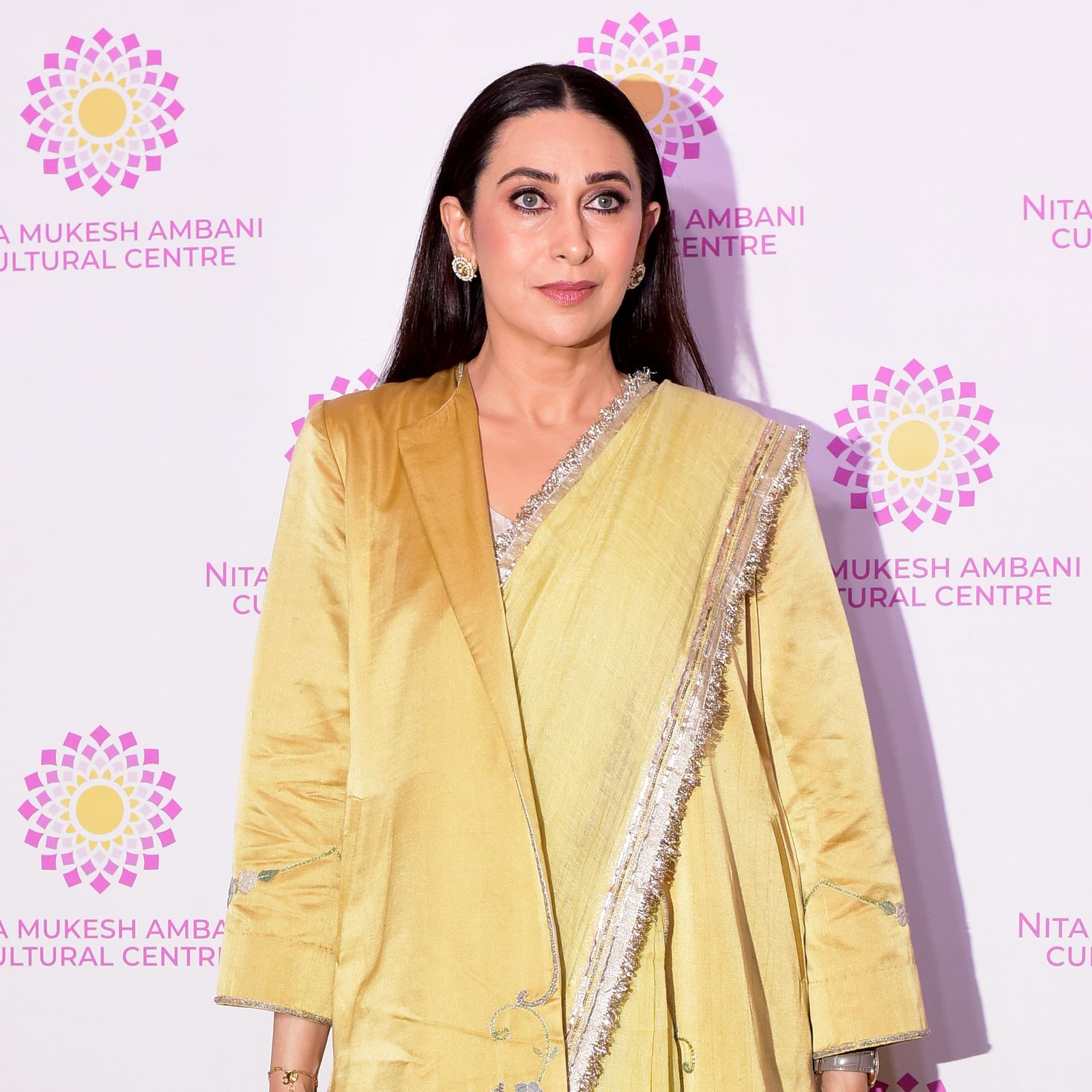 Karisma Kapoor redefines the classic sari with a jacket-layered silhouette in butter yellow